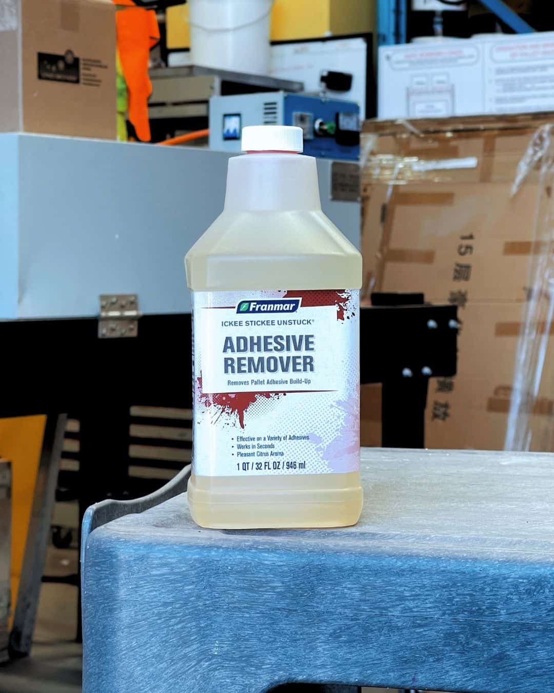 Bottle of Franmar Adhesive Remover on a washout bench in a Melbourne screenprinting studio, used for removing pallet glue and spray adhesives during screen reclamation in Australia.
