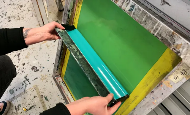 screen being coated with screen coater by screen printer