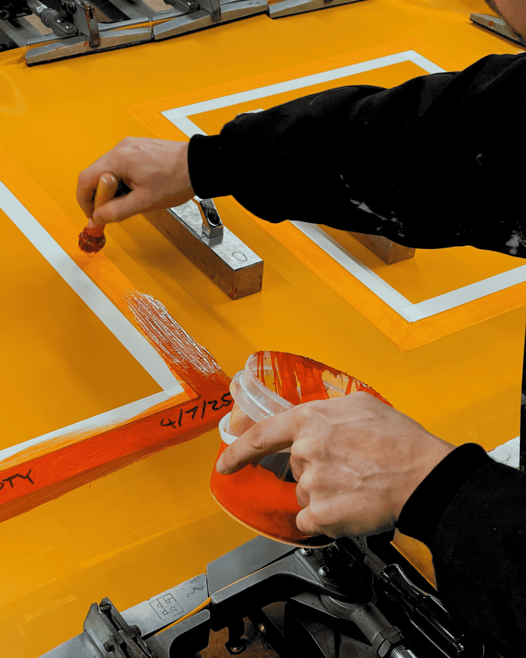 Close detail shot of hands working in the mesh room during re-meshing