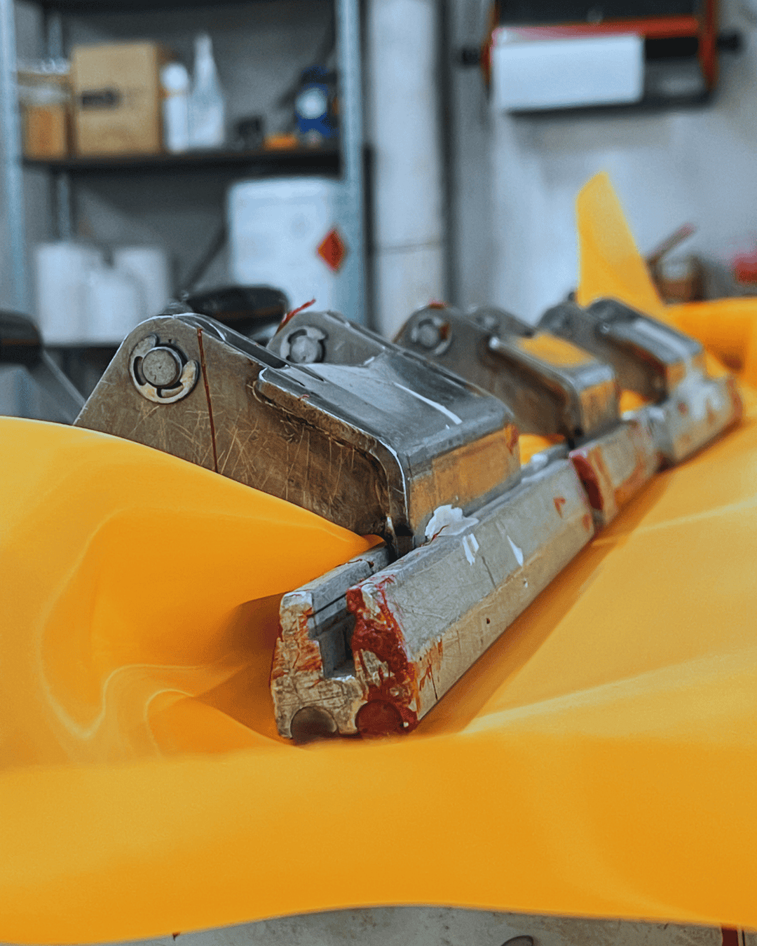 Close-up of screen clamps biting down on mesh before pneumatic clamps stretch the mesh