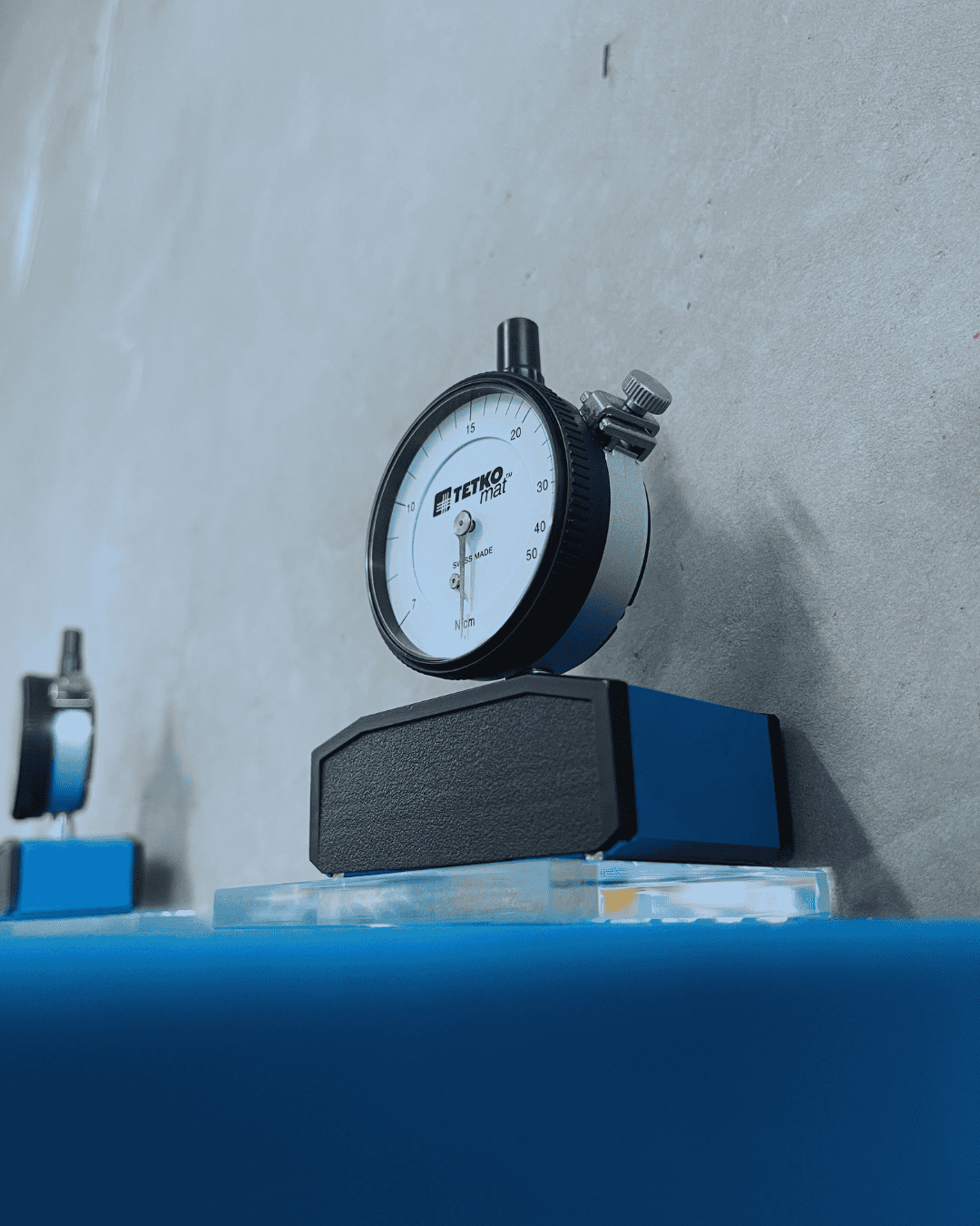 Tension meter sitting on a glass surface awaiting use