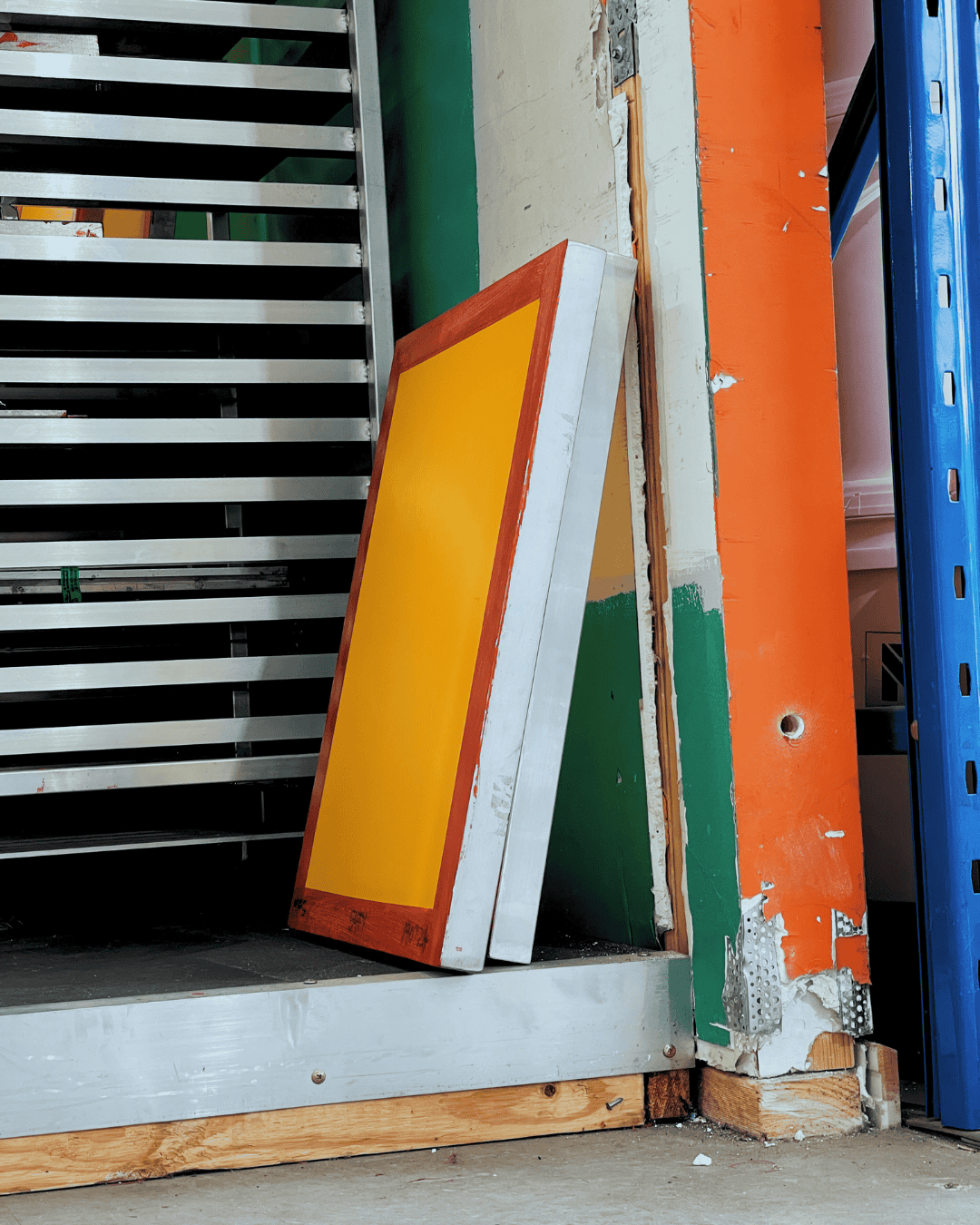 Multiple re-meshed screens leaning against a wall after trimming