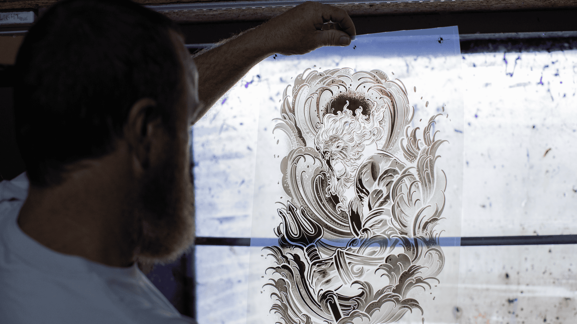 Manual printing of Project Poseidon on an M&R screenprinting press.