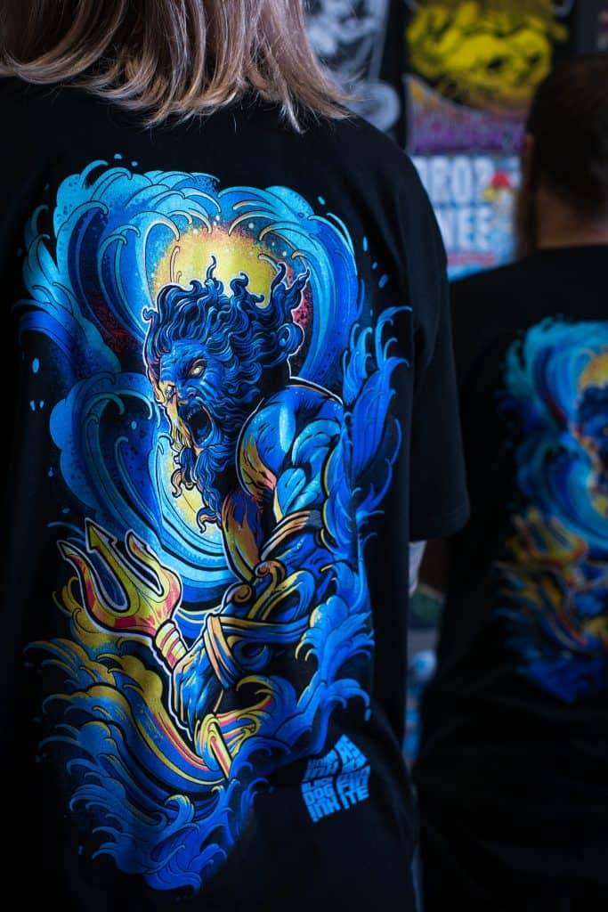 A Project Poseidon tee shirt screenprinted in Port Macquarie by BlackDog Ink using the Union Ink UNIMIX ink mixing system from the UPLC range. The product is exclusively supplied in Australia by Jones Brothers in Melbourne. Artwork by Minnie Longstaff on an AS Colour garment, showcasing high-detail professional screenprinting relevant to the Melbourne and Australian screenprinting industry.