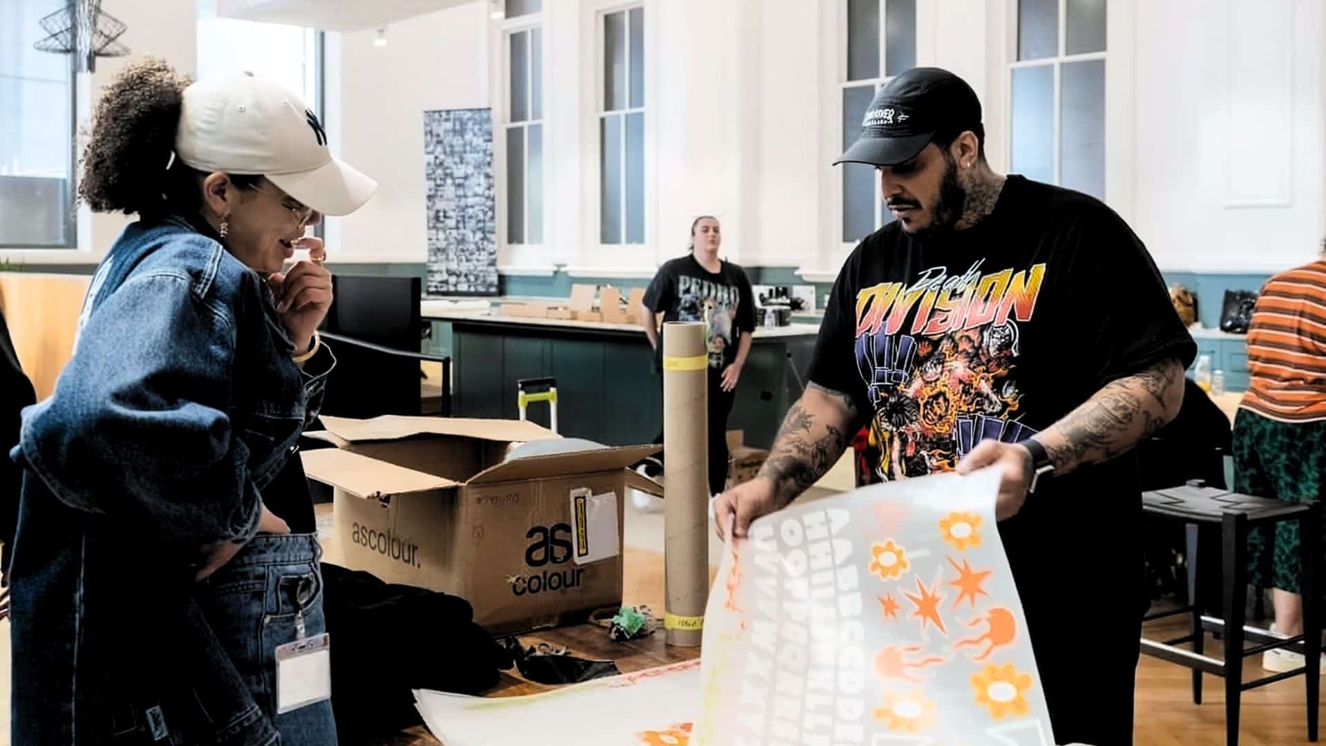 Behind-the-scenes view of garment printing process at Halo Print Co, showing workflow and shop environment