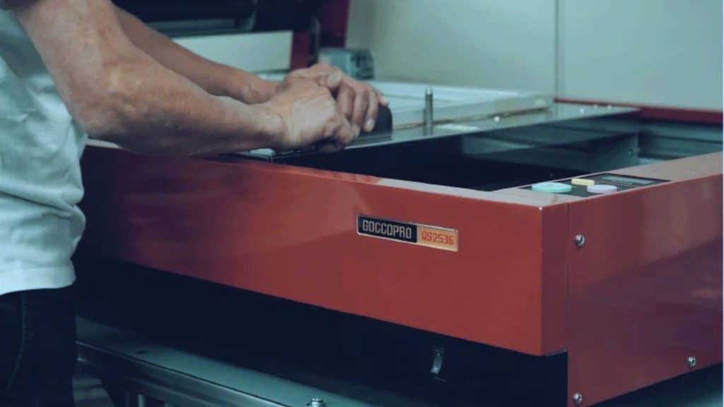 Behind-the-scenes view of garment printing process at Halo Print Co, showing workflow and shop environment